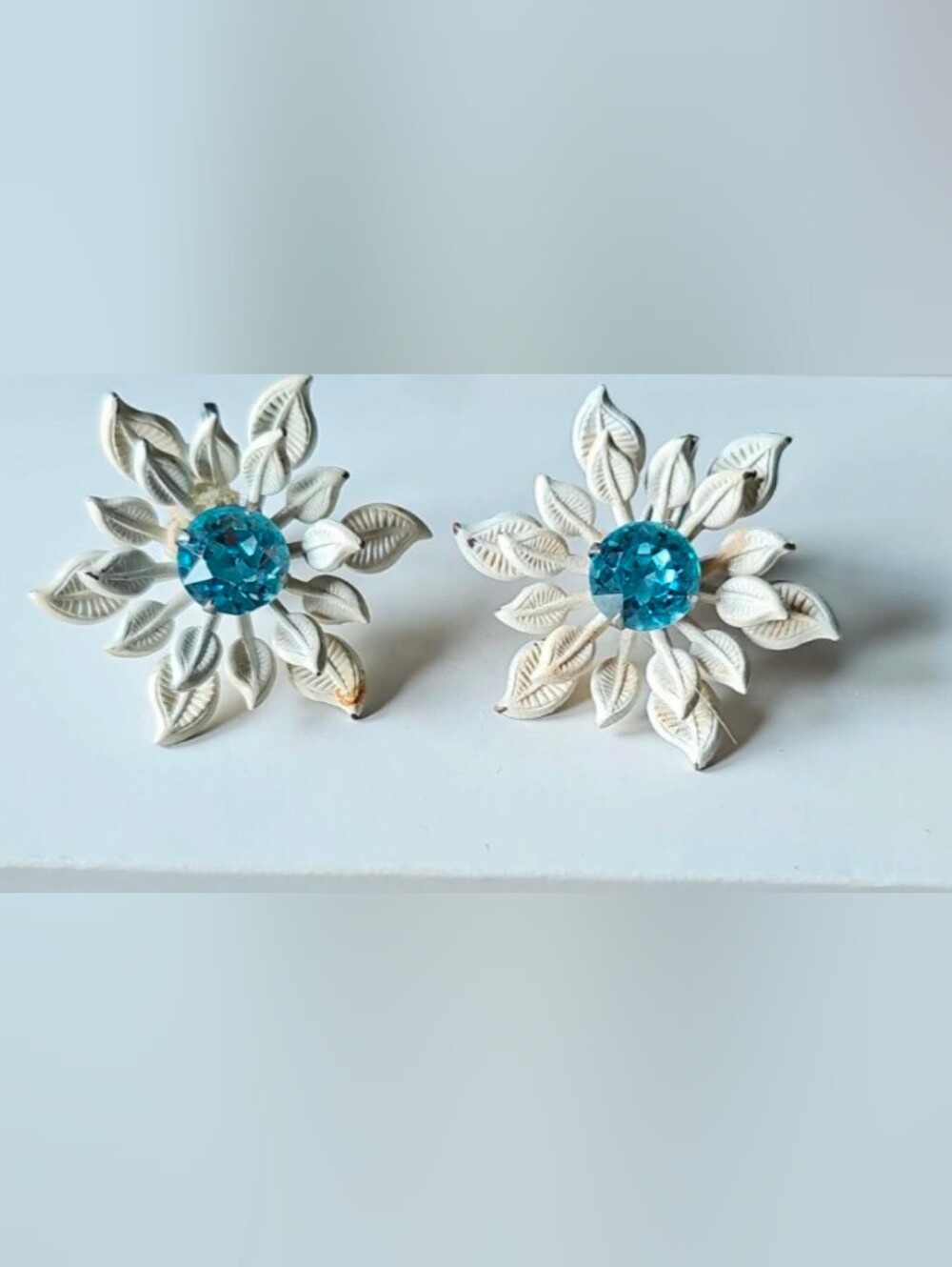 White Enamel Floral Motifs Clip On Earrings with A Bright Blue Rhinestone